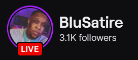 BluSatire's Twitch logo and follower count (3.1k). Logo is a black man in a white and blue shirt. The image links to BluSatire's Twitch page.