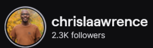 Chrislaawrence's Twitch logo and follower count (2.3k). Logo is a smiling bald black man in an orangeish-brown shirt. Image links to Chrslaawrence's Twitch page.