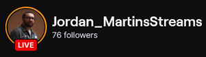 Jordan_MartinsStreams' Twitch logo and follower count (76). Logo is a picture of a black man in glasses, wearing a green shirt.
Image links to Jordan_MartinsStreams' Twitch page.
