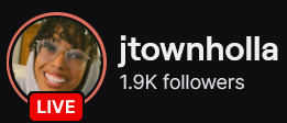 JTownHolla's Twitch logo and follower count (1.9k). Logo is a picture of a smiling black woman, wearing glasses and a white/grey hoodie. Image links to JTownHolla's Twitch page.