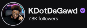 KDotDaGawd's Twitch logo and follower count (7.8k). Logo is a picture of a black man with a dark brown afro, wearing a black shirt, and resting his glasses low on his nose giving a side eye look to the left. Image links to KDotDaGawd's Twitch page.