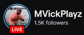 MVickPlayz's Twitch logo and follower count (1.5k). Logo is a picture of a black man with a full beard wearing a black baseball cap and salmon colored shirt, posing by the lake. Image links to MVickPlayz's  Twitch page.
