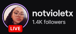 NotVioletX's Twitch logo and follower count (1.4k). Logo is a picture of a black woman with long and curly hair, pulled back into a sleek ponytail, and glasses. Image links to NotVioletX's Twitch page.