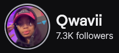 Qwavii's Twitch logo and follower count (7.3k). Logo is a picture of a black woman with glasses wearing a red baseball cap and a black hoodie with the hood over the cap. Image links to Qwavii's Twitch page.
