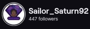 Sailor_Saturn92's Twitch logo and follower count (447). Logo is a small cartoon portrait of a black woman with a small afro, surrounded by a purple diamond. Image links to Sailor_Saturn92's Twitch page.
