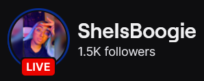 SheIsBoogie's Twitch logo and follower count (1.5k). Logo is a picture of a black woman with long light blue hair wearing glasses. Image links to SheIsBoogie's Twitch page.
